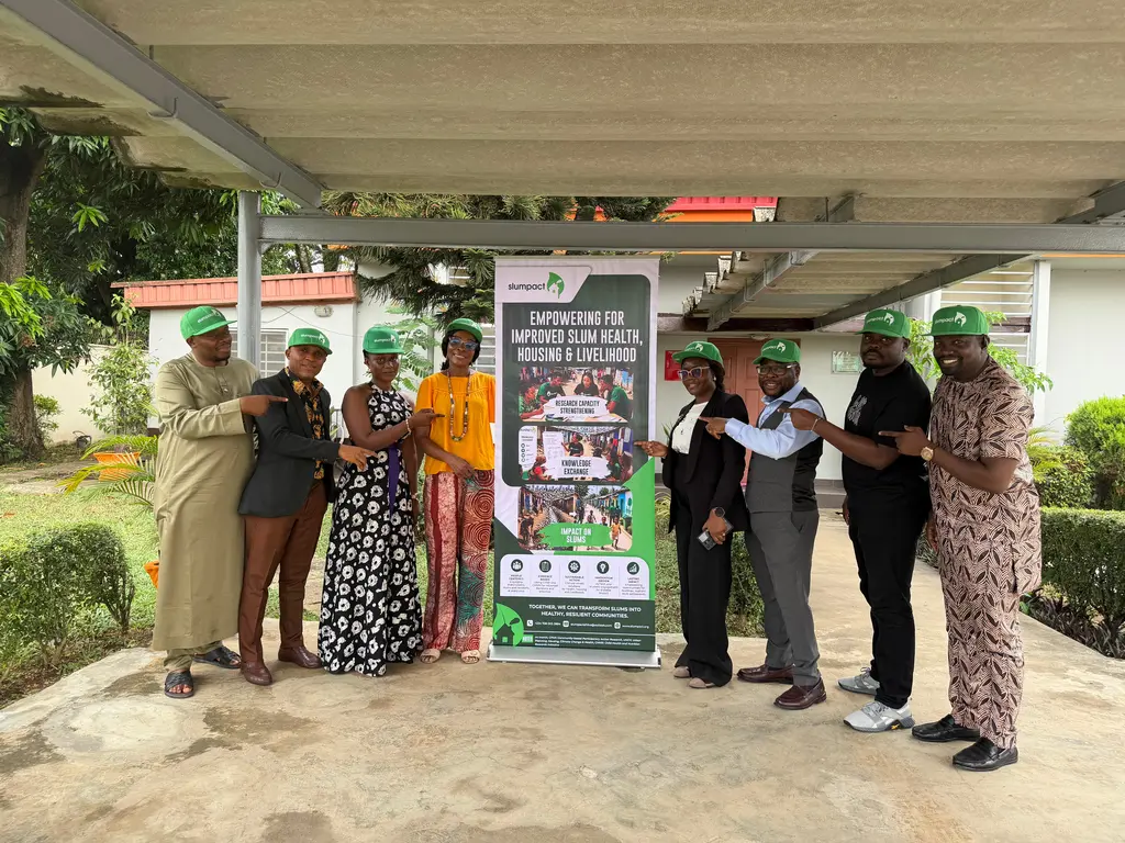 SlumPact committee members with a poster